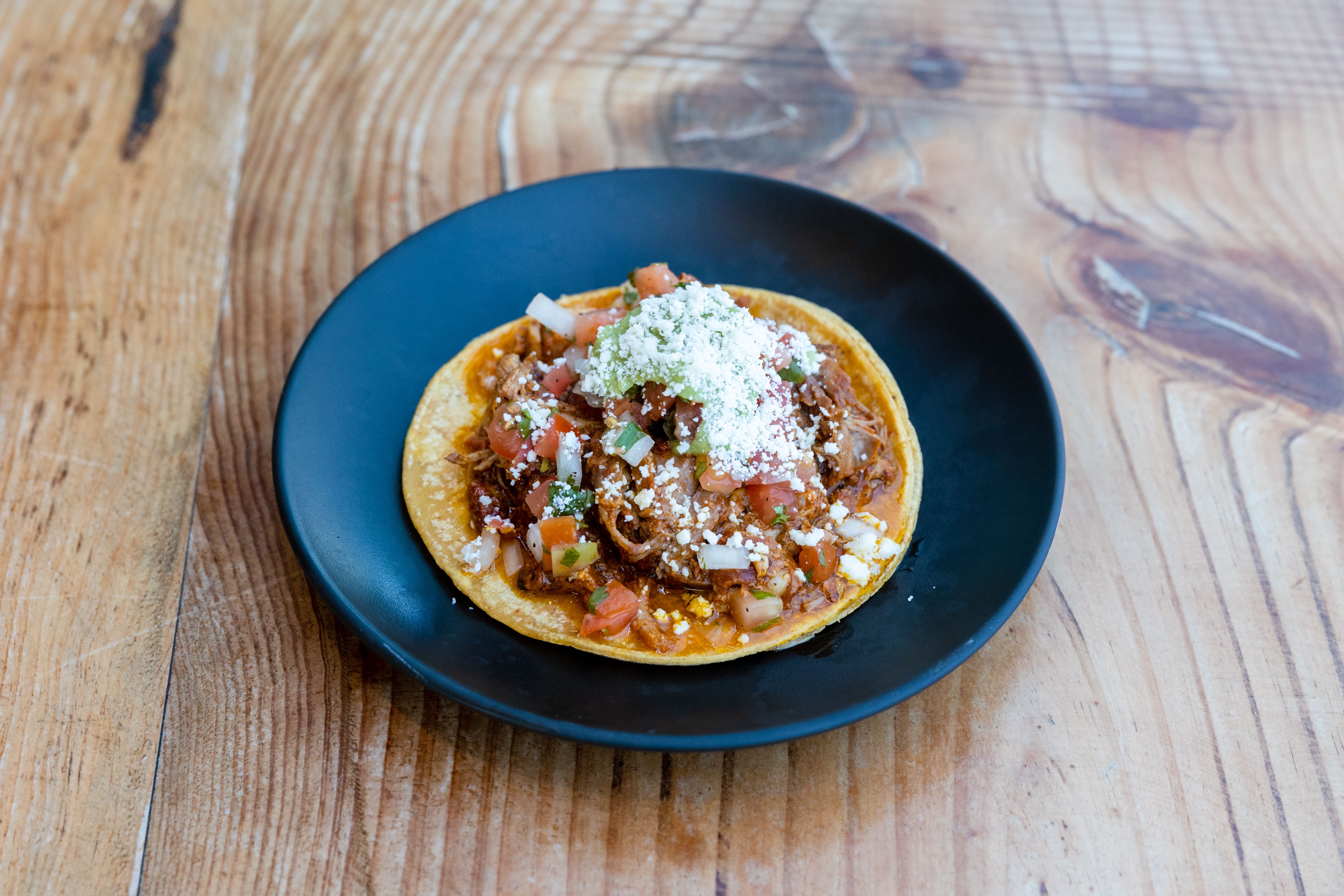 Birria Vampiro on a crispy tostada with cheese