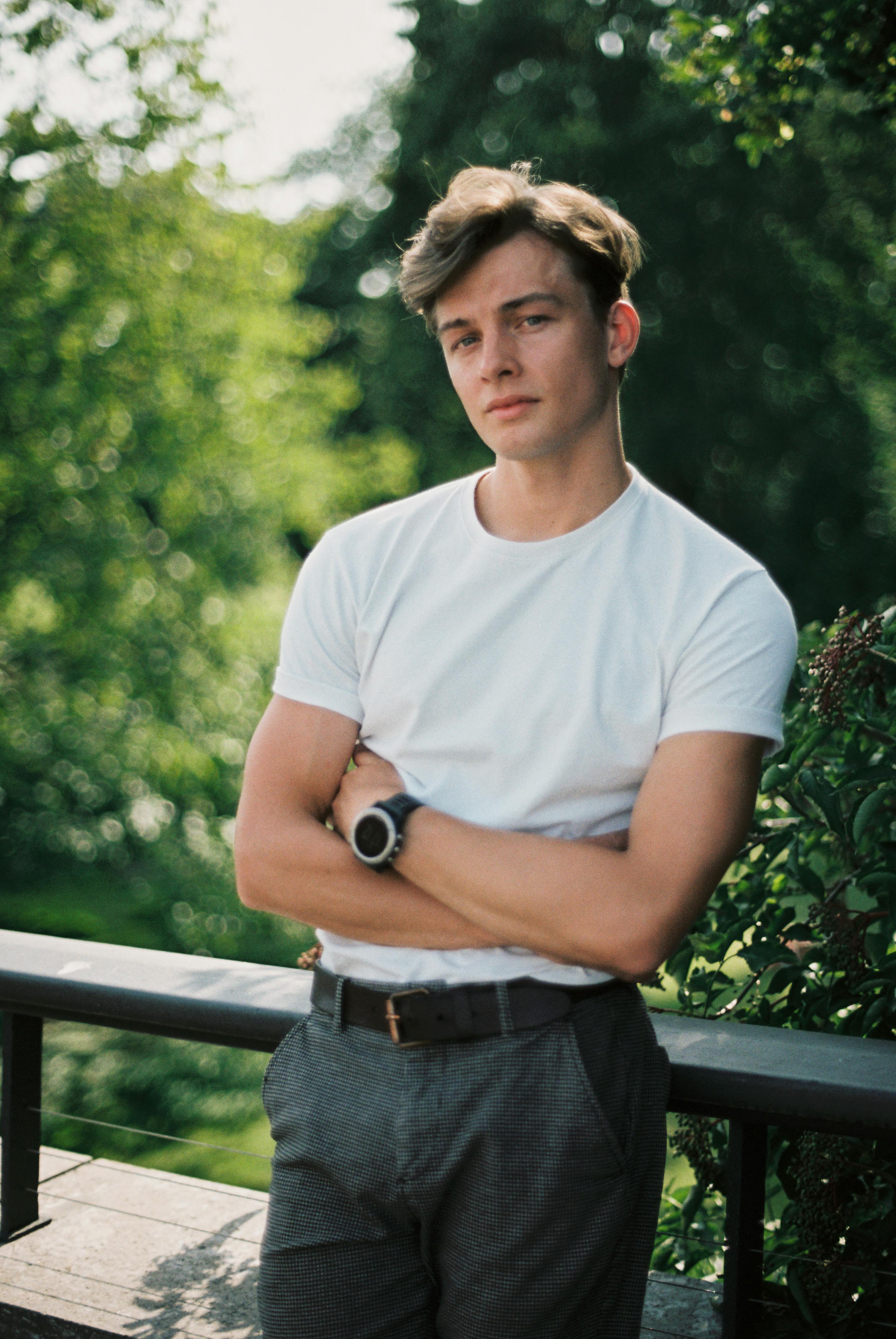 a young man in a white shirt and black pants