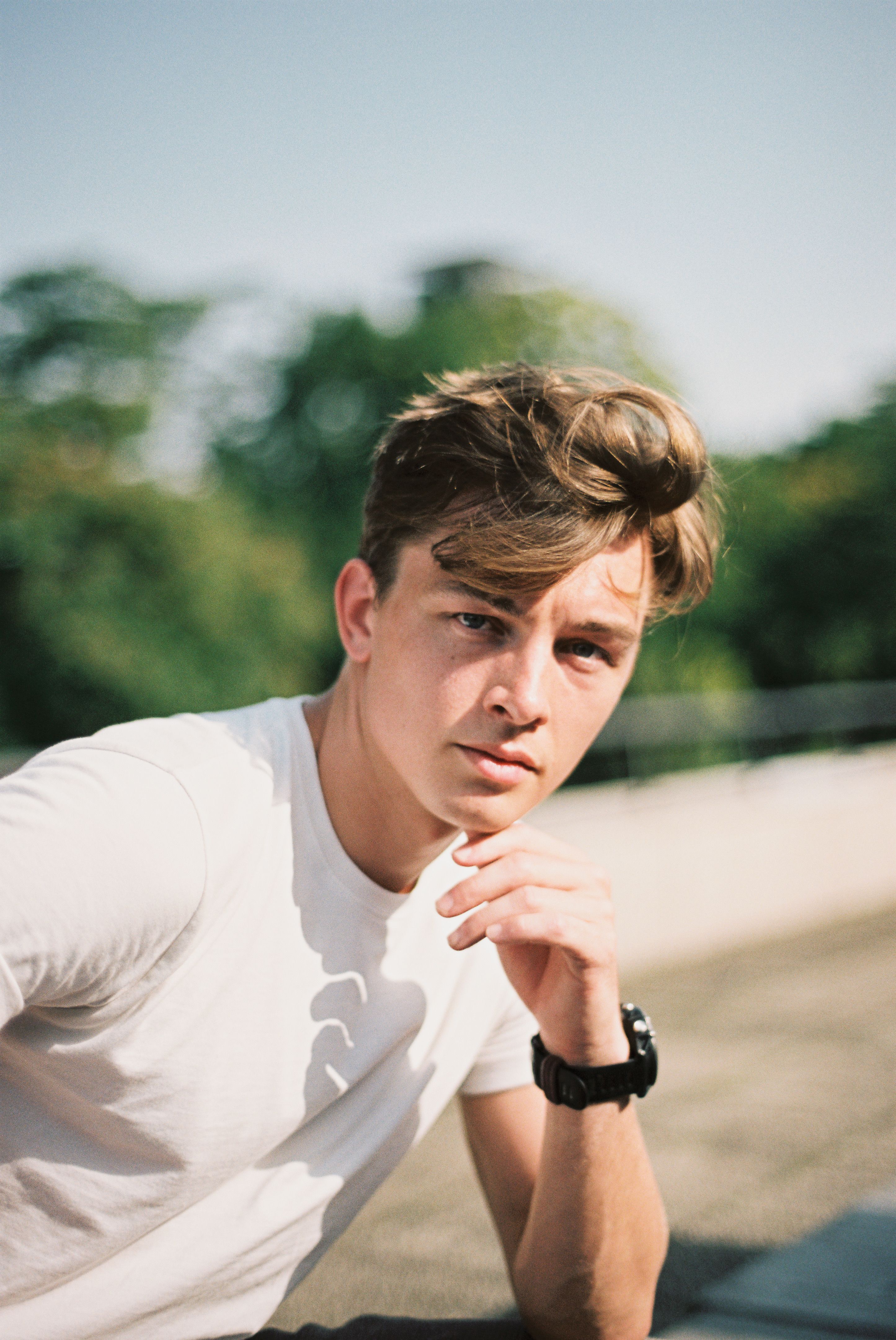 Relaxed young man in Berlin enjoying summer outdoors.