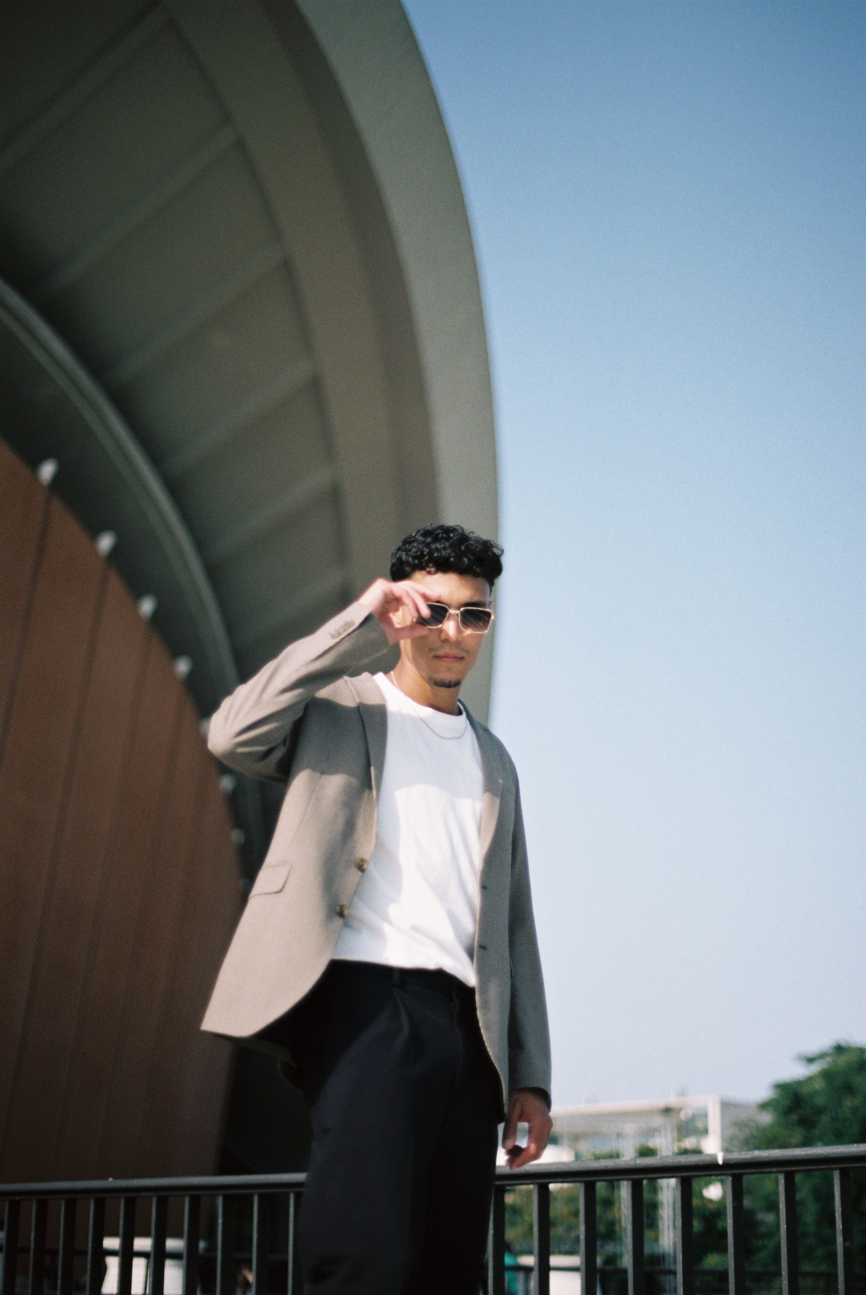 A man in a suit and sunglasses standing outside · Free Stock Photo