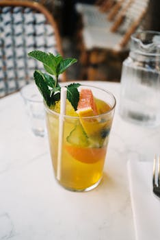A bright citrus and mint mocktail served in a glass, perfect for a refreshing summer day.