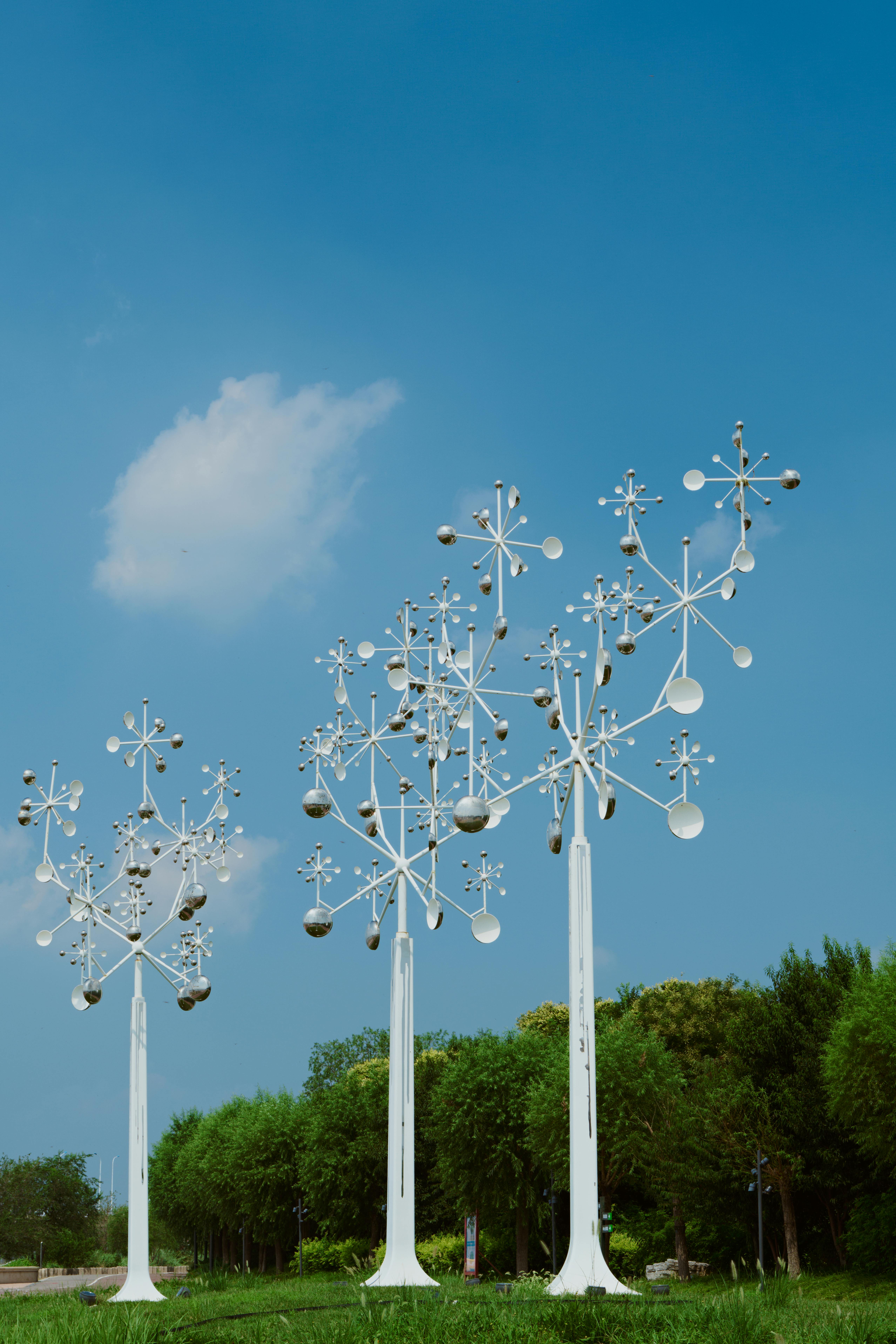 a group of metal sculptures in the shape of trees