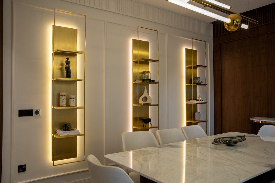 Styling Shelves and Surfaces Like a Pro — Sophisticated dining room interior featuring illuminated shelves and sleek decor.