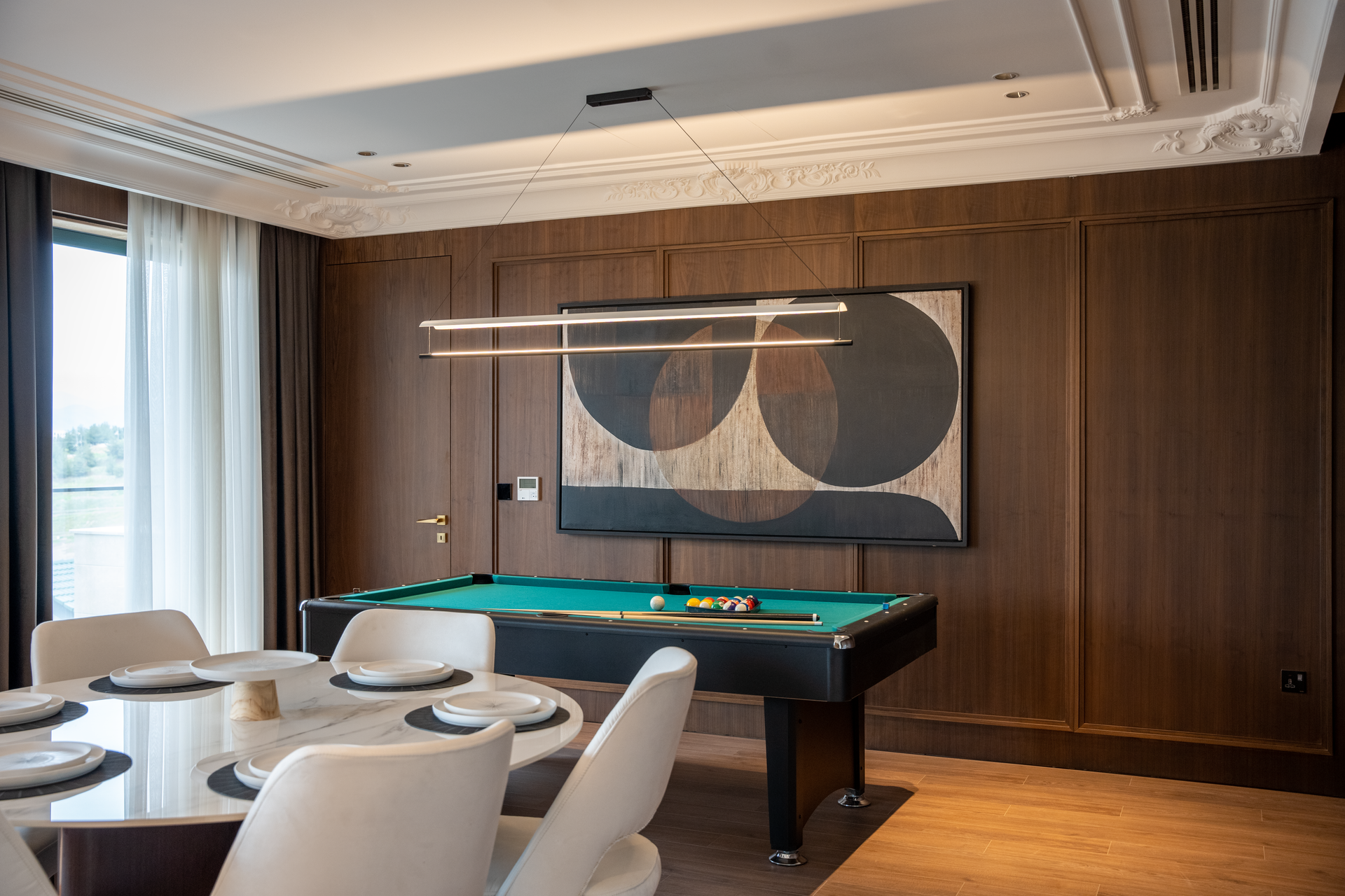 Stylish luxury interior featuring billiards table, modern furniture, and contemporary decor.