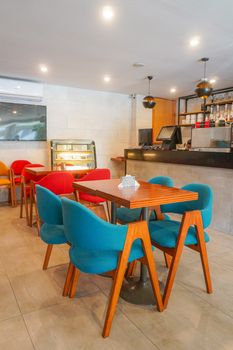 Bright and cozy cafe interior in Islamabad with colorful seating and a minimalist design.