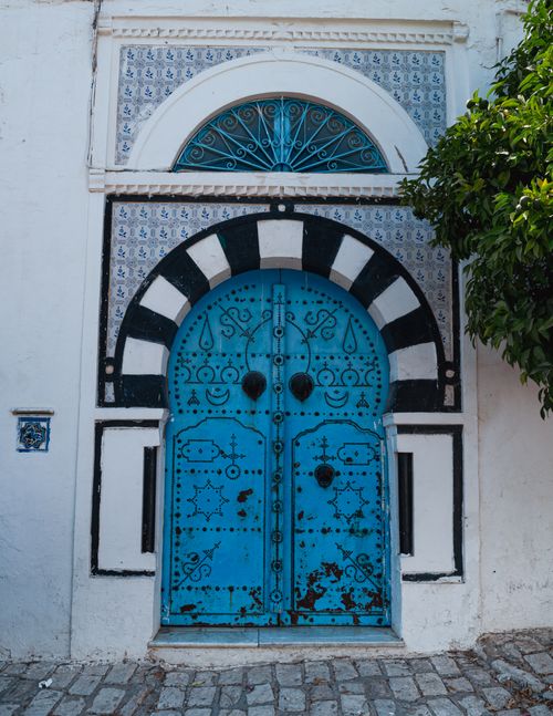 Free Ornate blue door in Carthage, Tunis showing traditional Tunisian architecture. Stock Photo