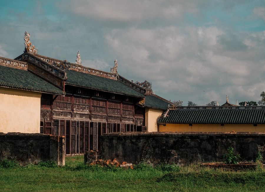 Traditional architecture in Hue, Vietnam showcasing intricate roof designs and historic woodwork.