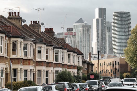View of traditional London houses against the modern Canary Wharf skyline.