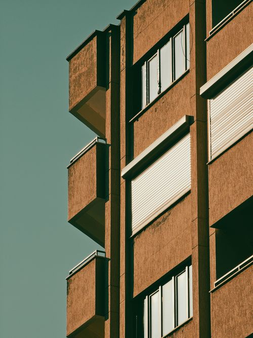 Free Close-up of a contemporary apartment building facade with balconies and windows. Stock Photo