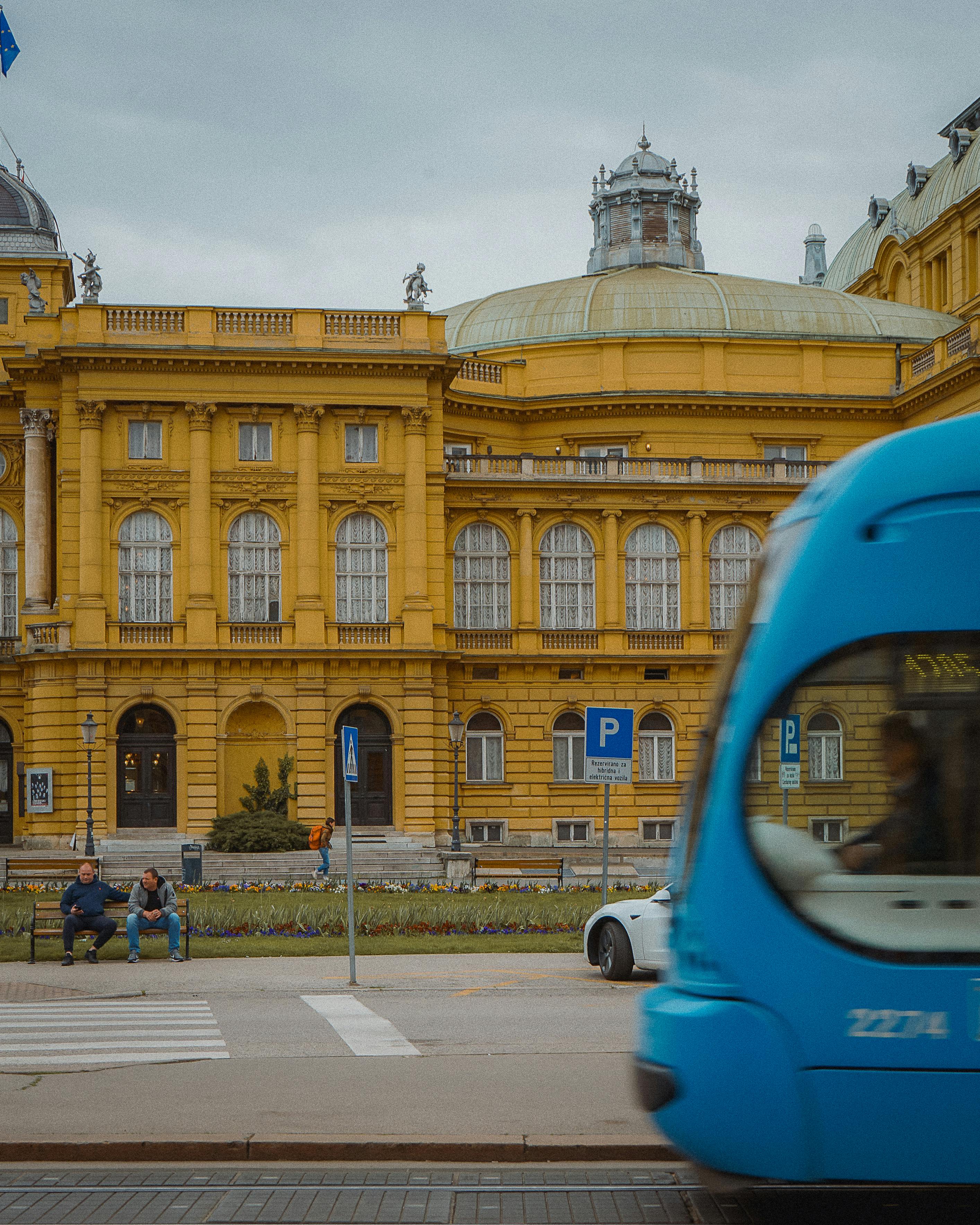 a blue bus is driving down the street