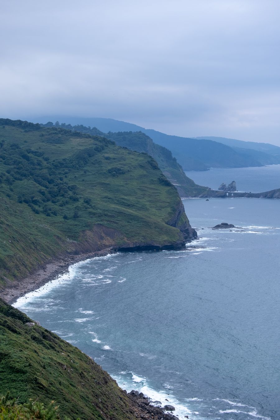 Green coastal headland above the sea — photo by Joost van Os on Pexels
