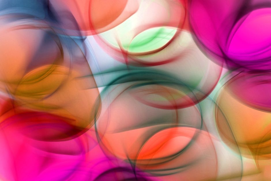 Vibrant abstract design of colorful light waves in motion, with dynamic curves and gradients.