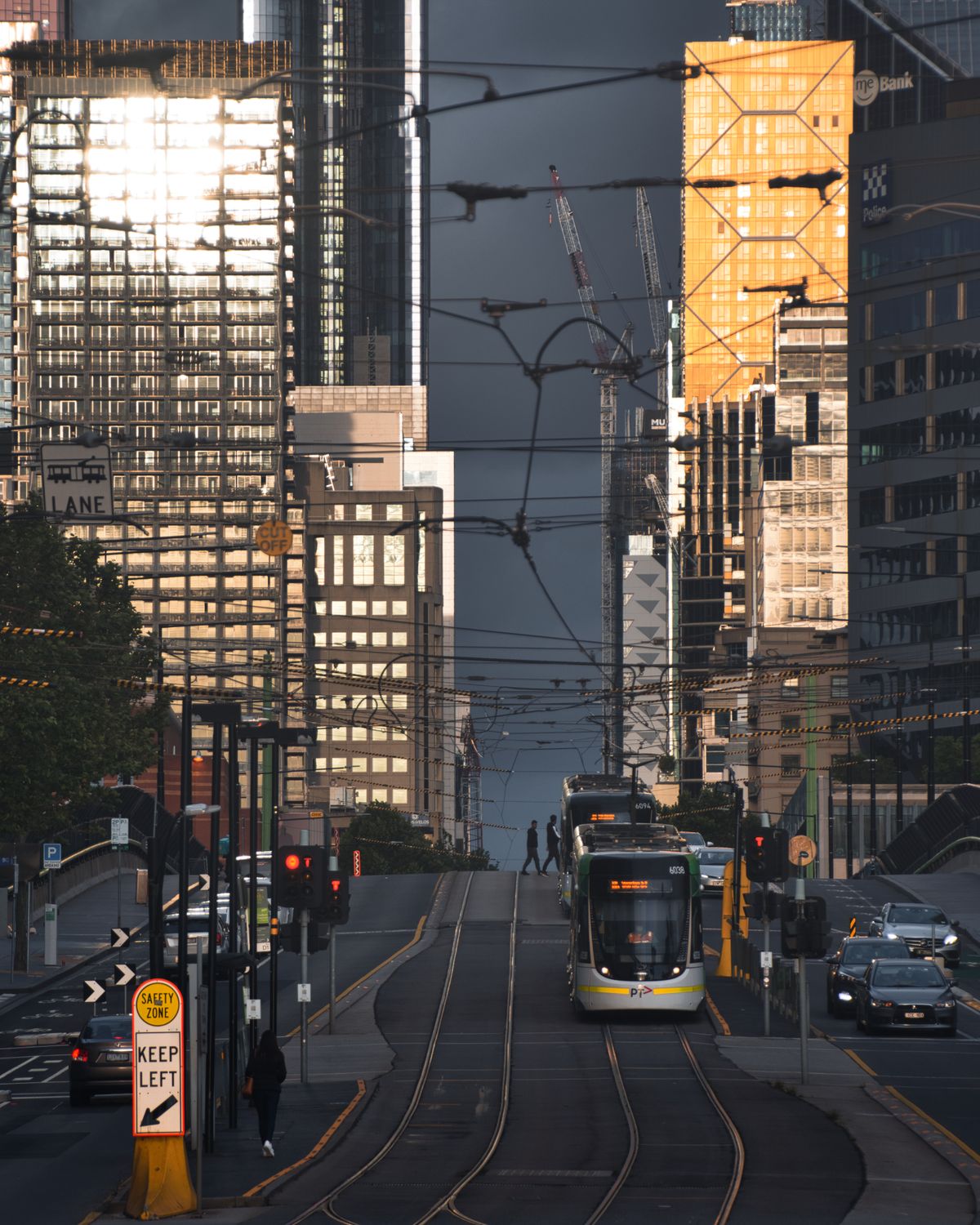 Melbourne CBD scene with a westbound tram on La Trobe Street surrounded by traffic and skyscrapers