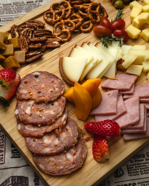 Free Appetizing charcuterie board featuring meats, cheeses, fruits, and nuts, perfect for gatherings. Stock Photo