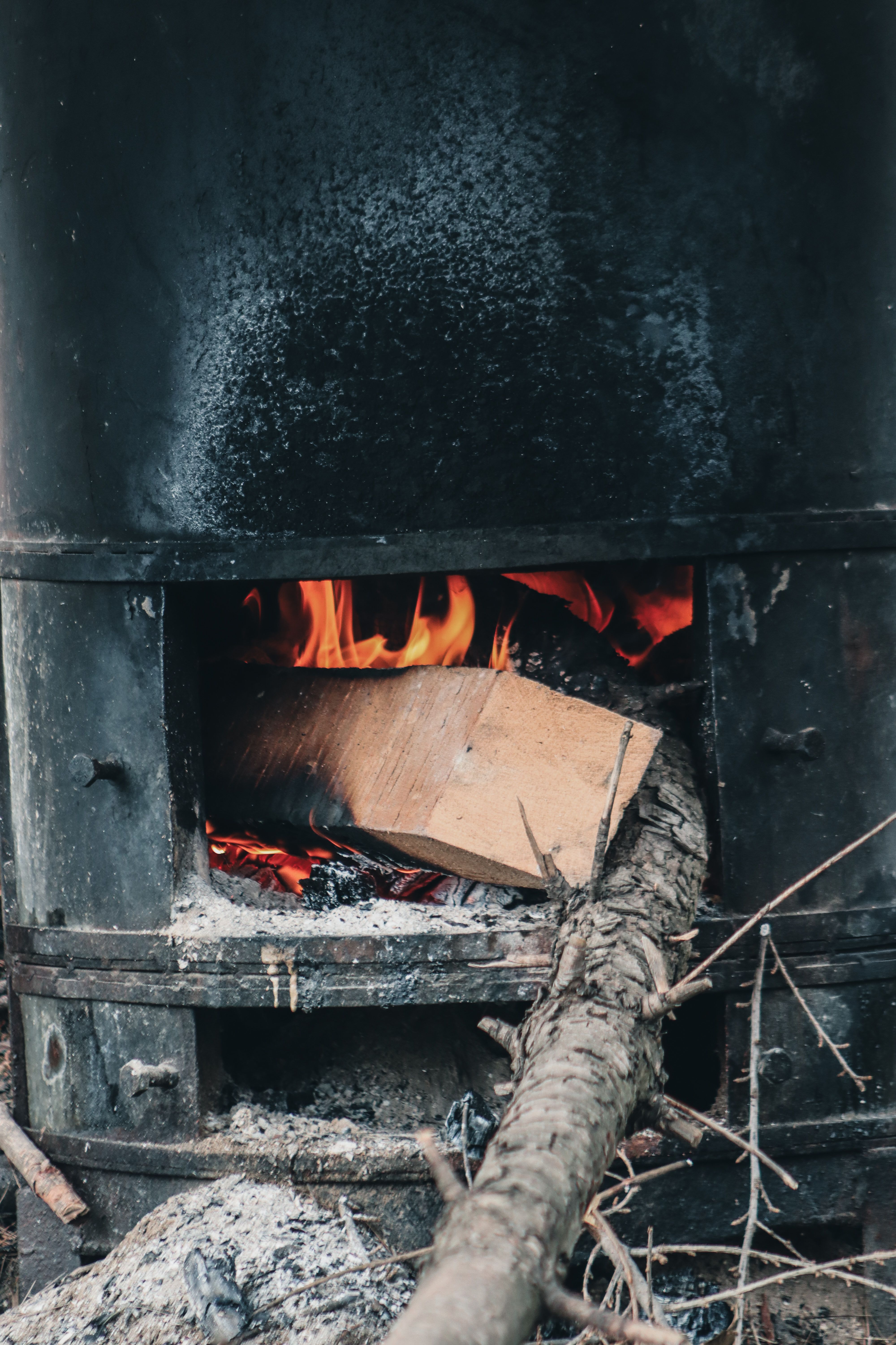 Boiling sap over wood fire in small sugarhouses