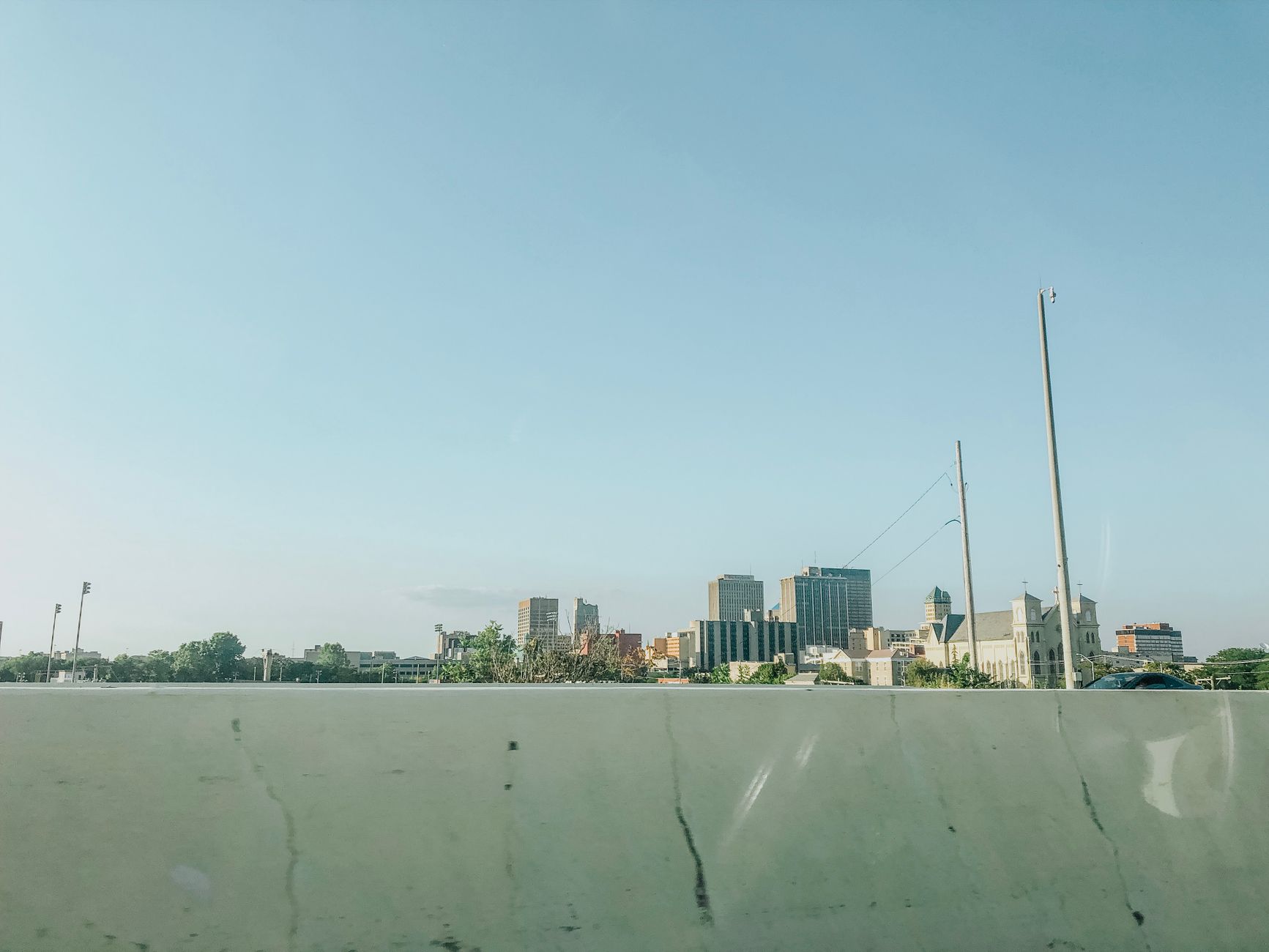 Scenic view of downtown Dayton skyline under a clear blue sky, ideal for urban landscapes.