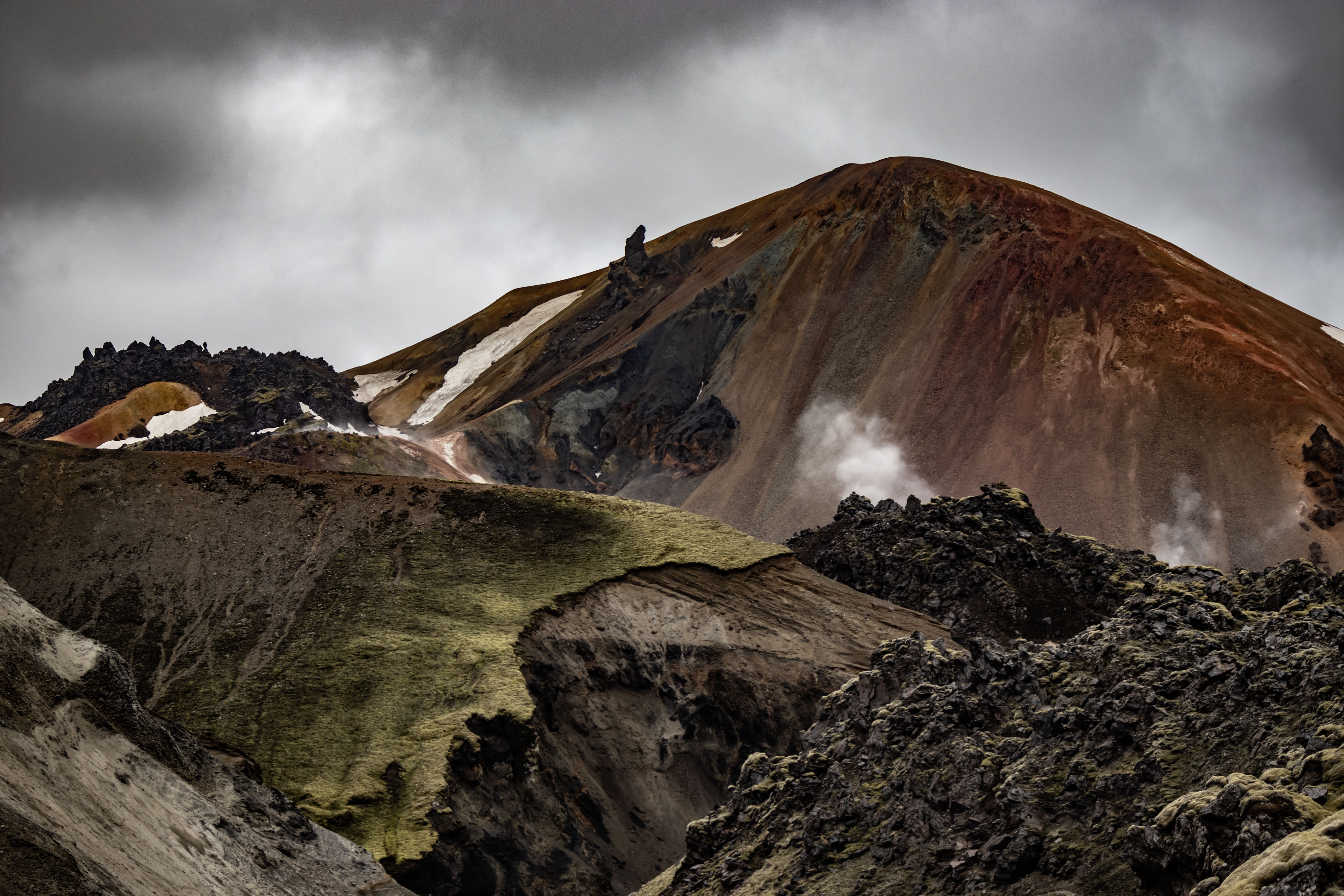 Explore the rugged volcanic terrain of Landmannalaugar, Iceland with dramatic skies and colorful mountains. Explore the rugged volcanic terrain of Landmannalaugar, Iceland with dramatic skies and colorful mountains.