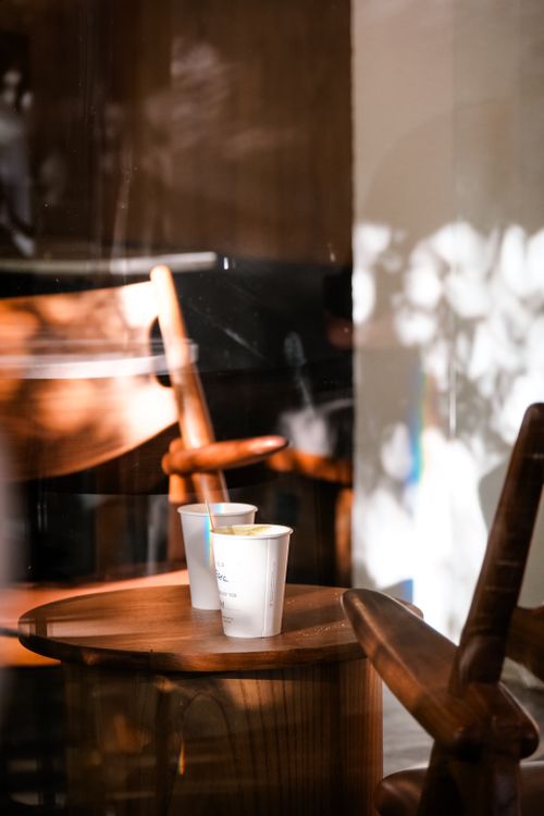 Free Warm light illuminating coffee cups and wooden chairs in an Istanbul café. Stock Photo
