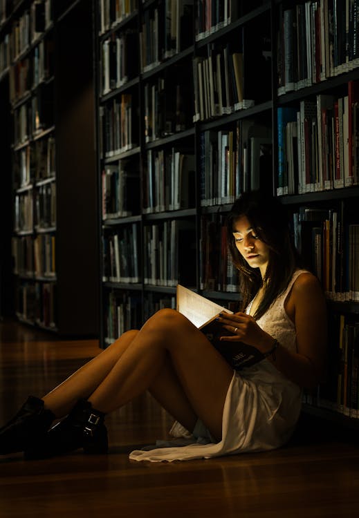Free Woman Leaning On Bookshelf Stock Photo