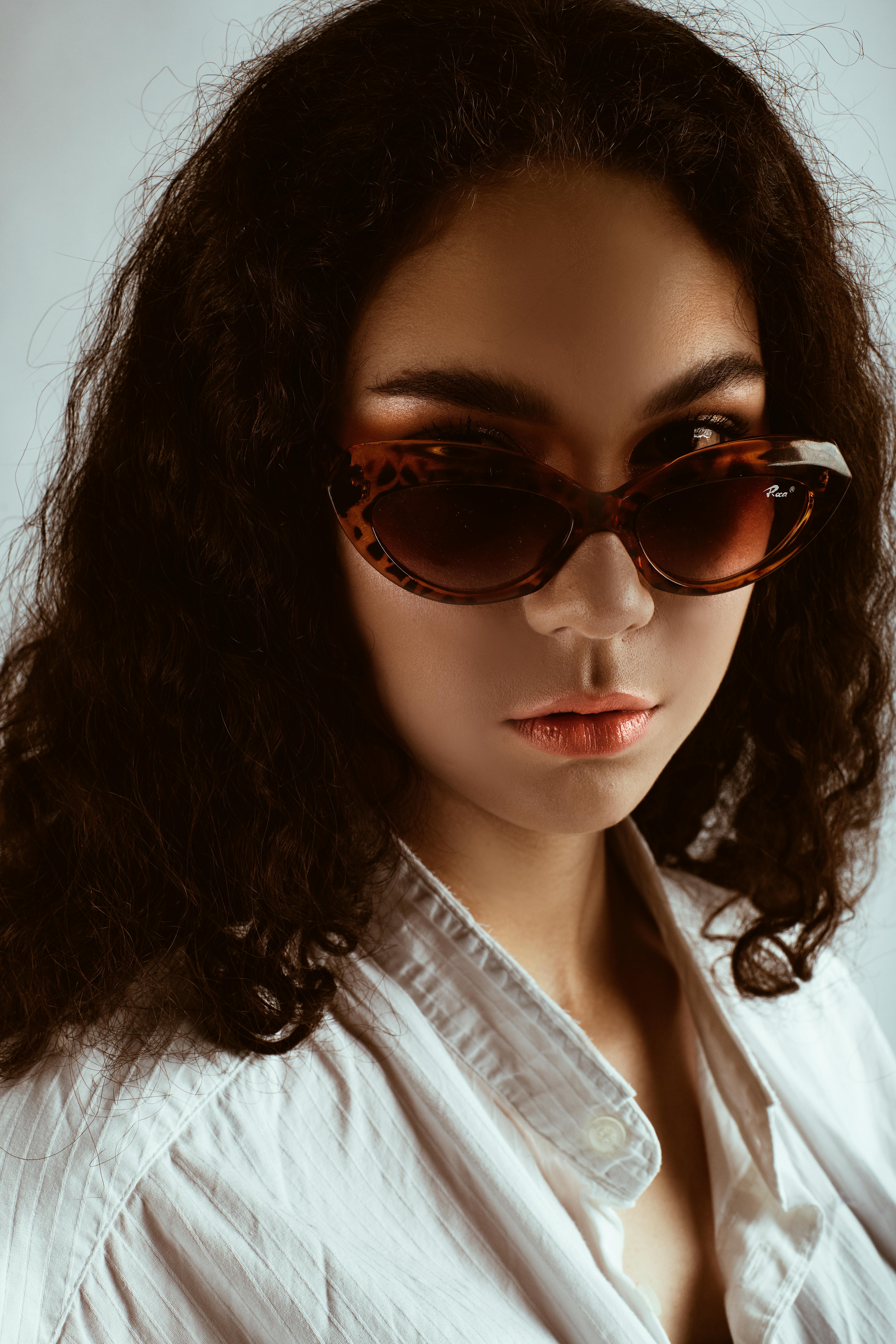 Portrait Photo of Woman in Sunglasses and White Shirt Posing