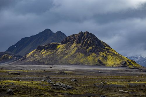 Free Explore the rugged volcanic landscapes of Iceland's highlands with dramatic clouds and vibrant moss. Stock Photo
