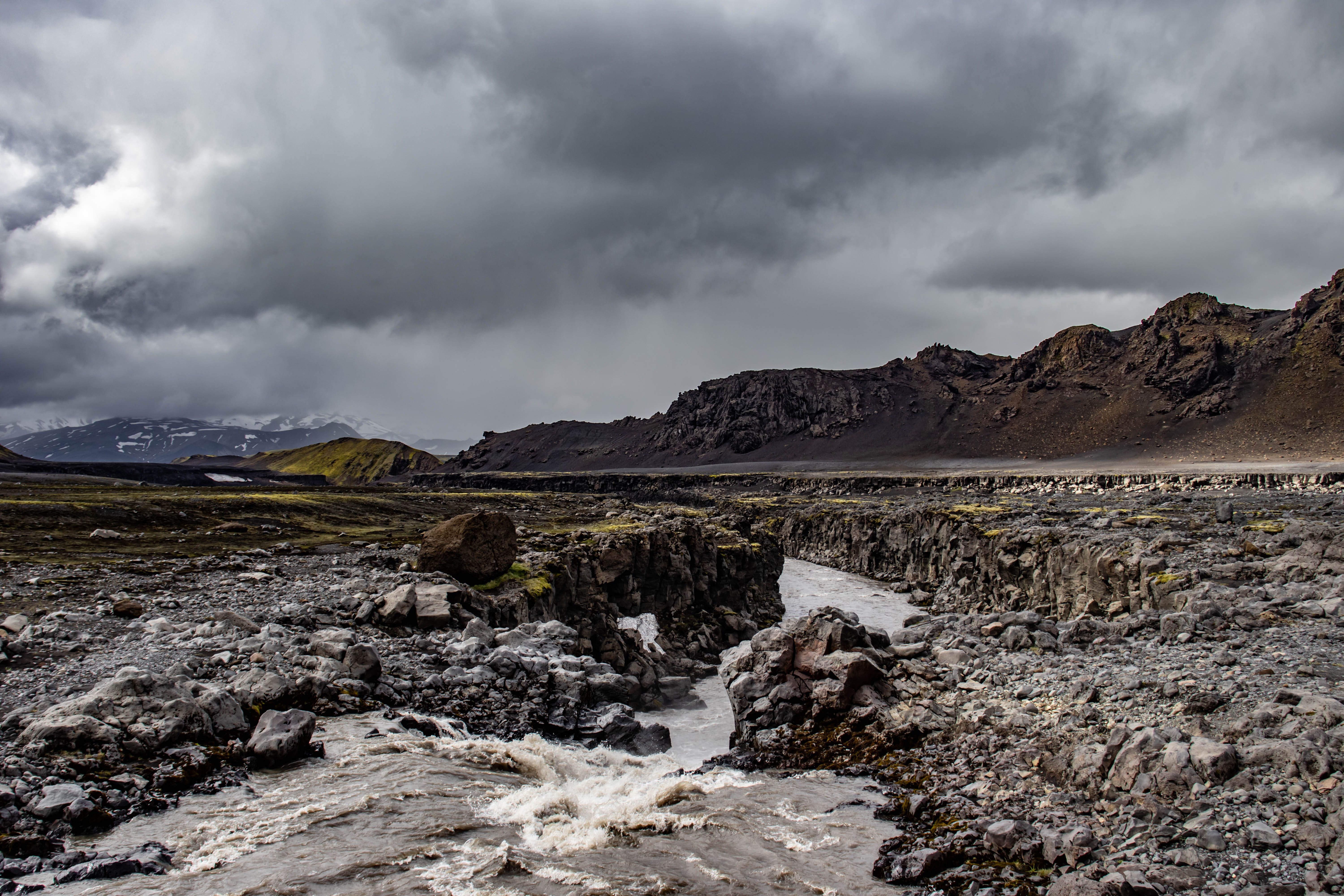 Rugged Icelandic terrain with a winding river under dramatic skies. Rugged Icelandic terrain with a winding river under dramatic skies.