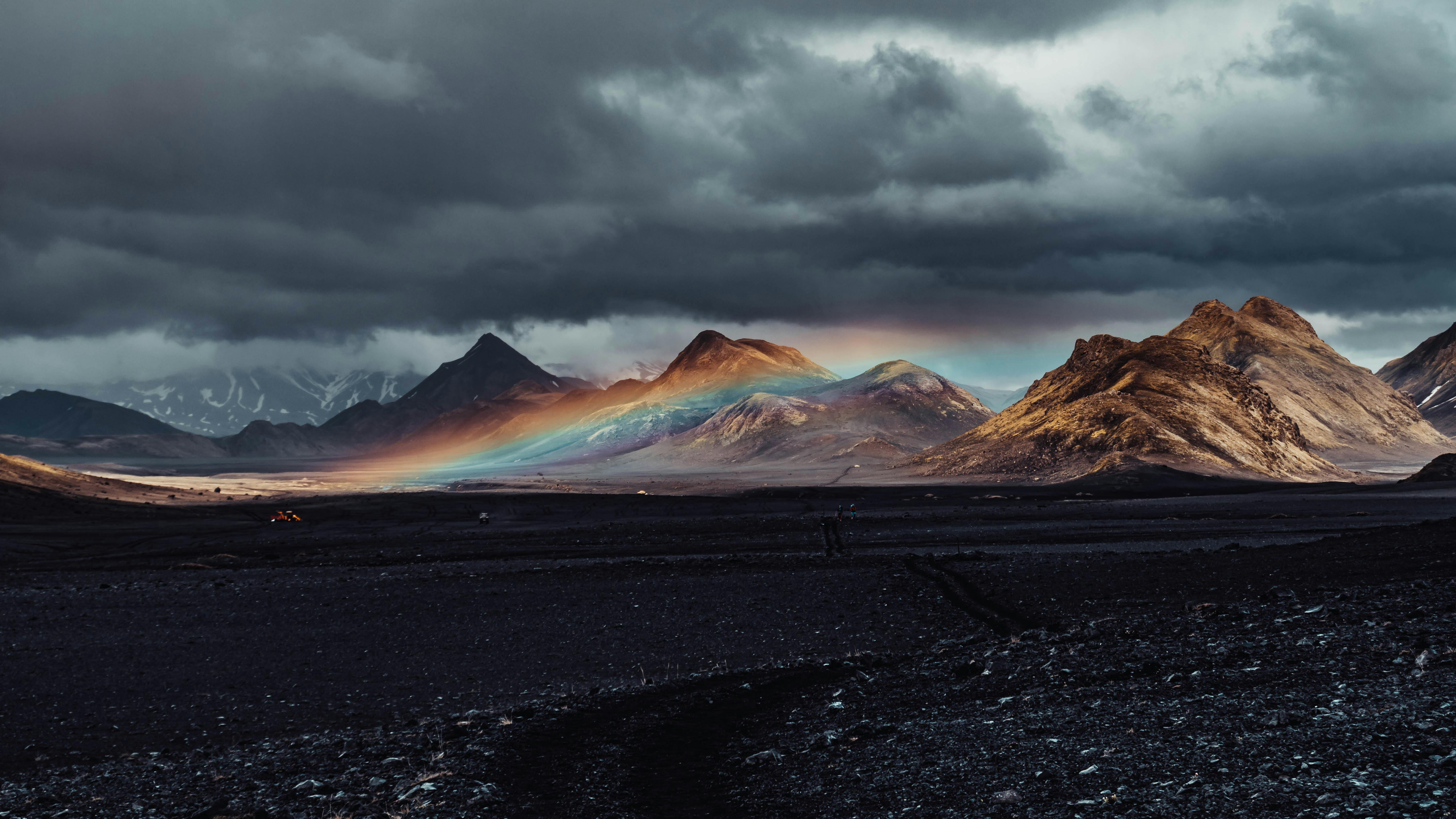 Prescription Goggle Inserts - A dramatic rainbow arcs over rugged Icelandic mountains under a stormy sky.