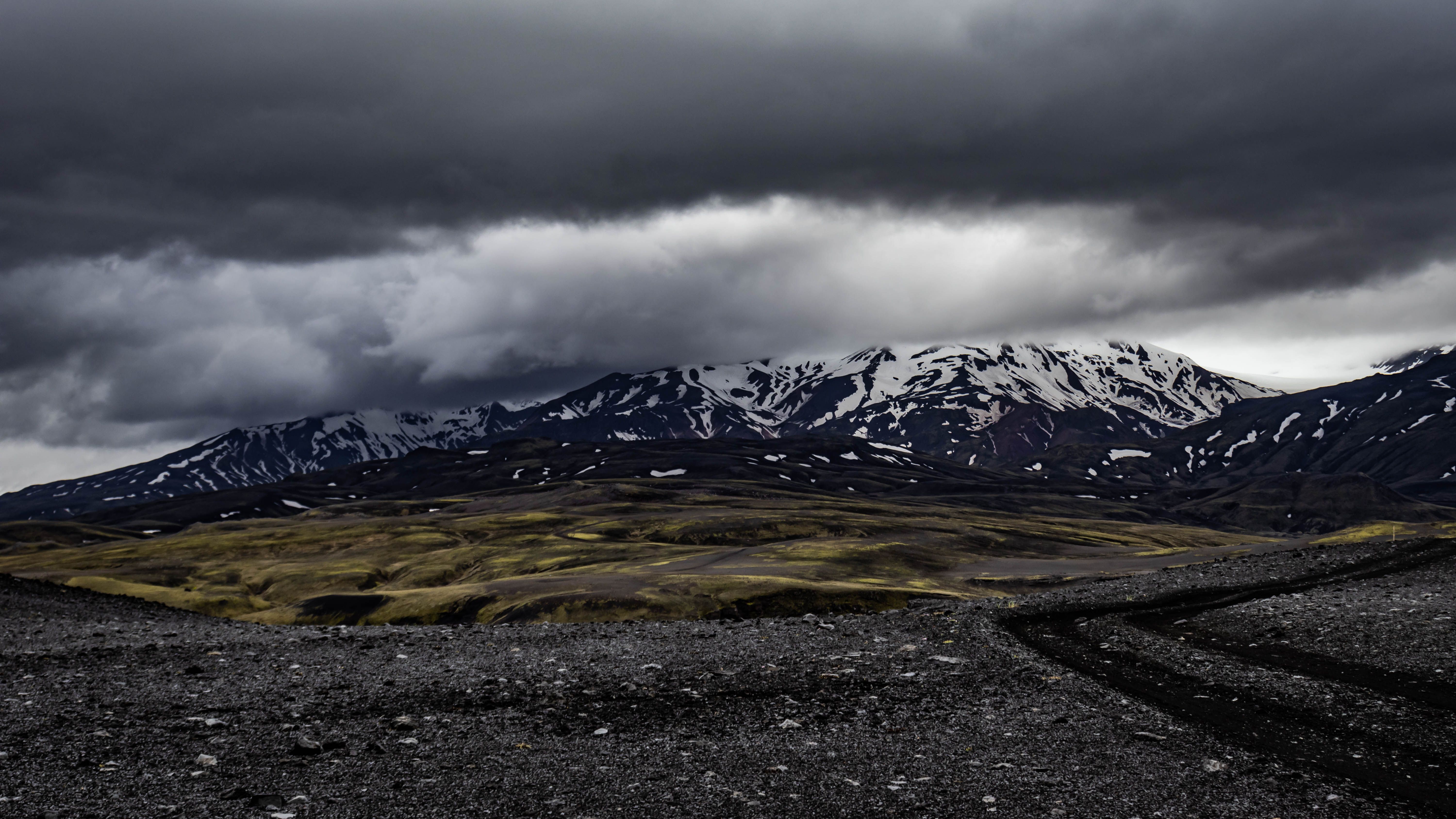 Explore the rugged and dramatic Icelandic mountain landscape under heavy clouds, perfect for adventure enthusiasts. Explore the rugged and dramatic Icelandic mountain landscape under heavy clouds, perfect for adventure enthusiasts.