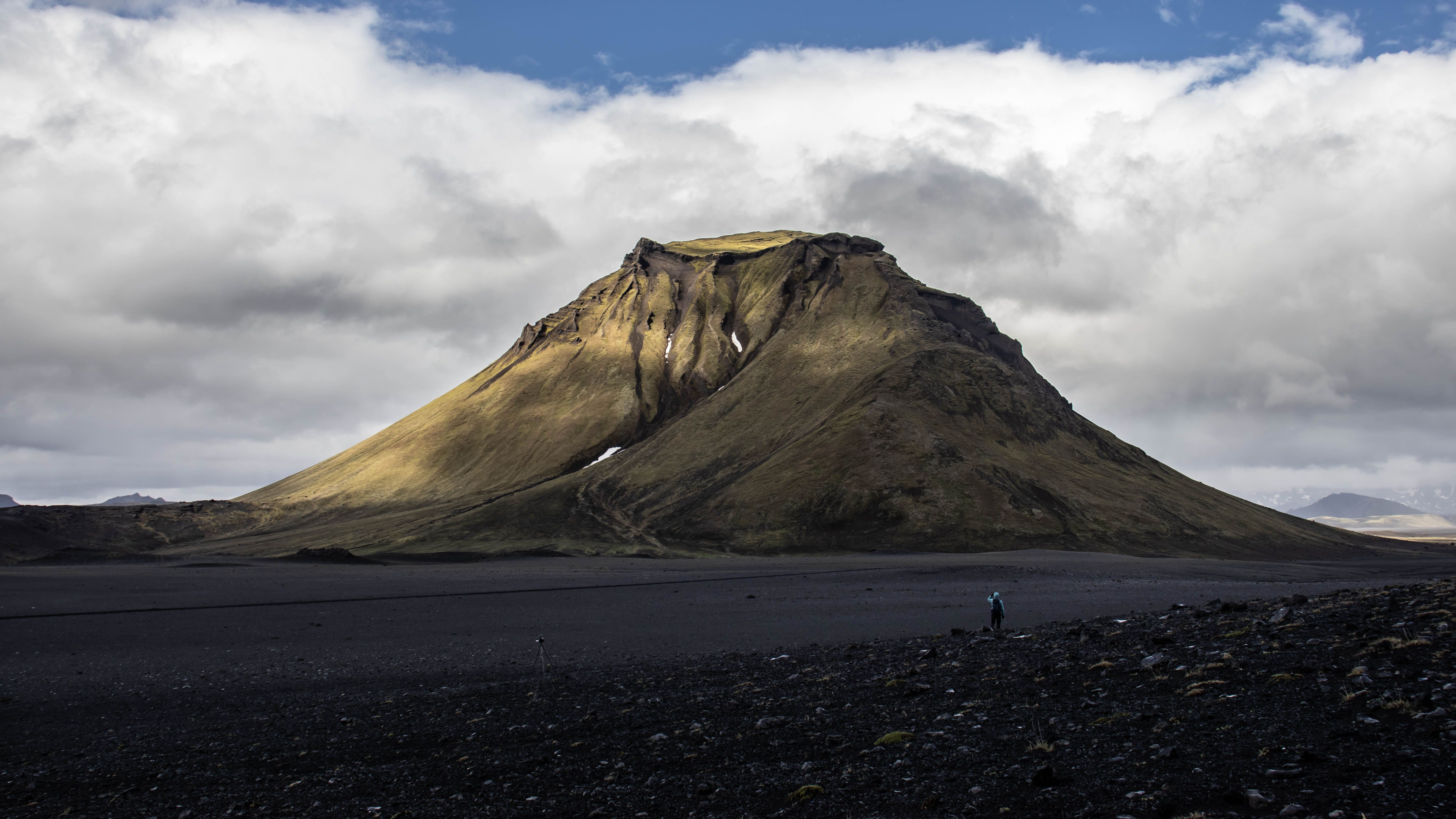 Stunning view of a volcanic mountain with dramatic clouds in Iceland, perfect for nature and travel themes. Stunning view of a volcanic mountain with dramatic clouds in Iceland, perfect for nature and travel themes.