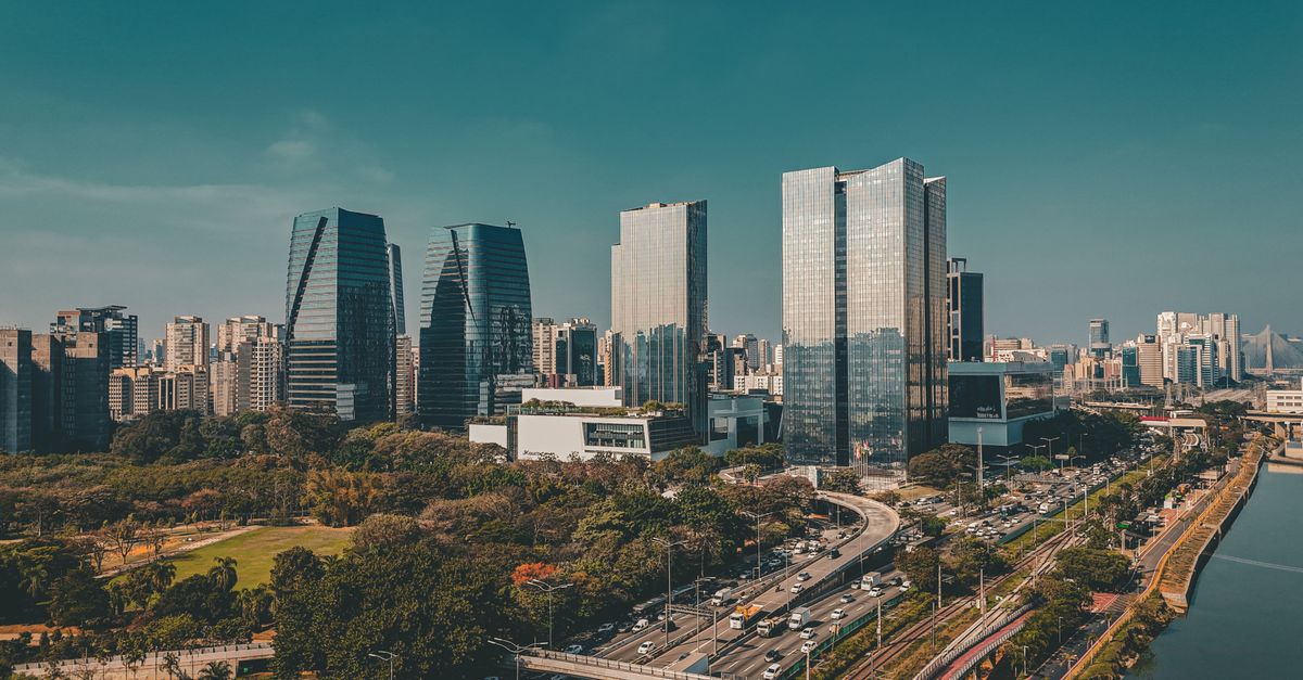 Explore the vibrant São Paulo skyline featuring modern skyscrapers, a bustling highway, and serene waterfront.