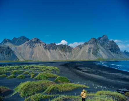 Majestic Vestrahorn mountain and black sand beach under a clear blue sky in Iceland.