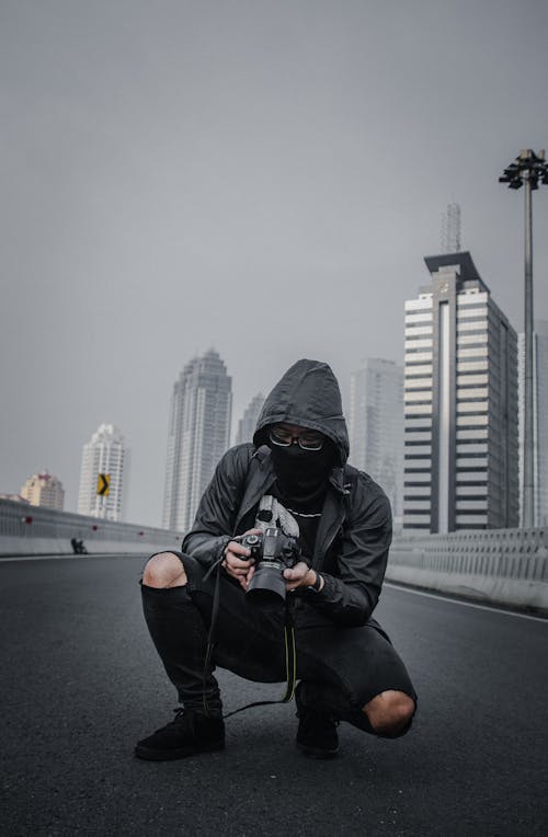 Photo of Person Holding DSLR Camera