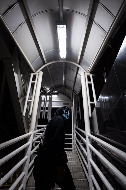 Person in Black Hoodie Standing on Stairs