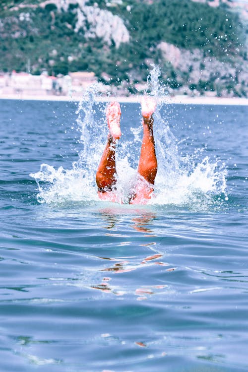 Person Diving Under Water