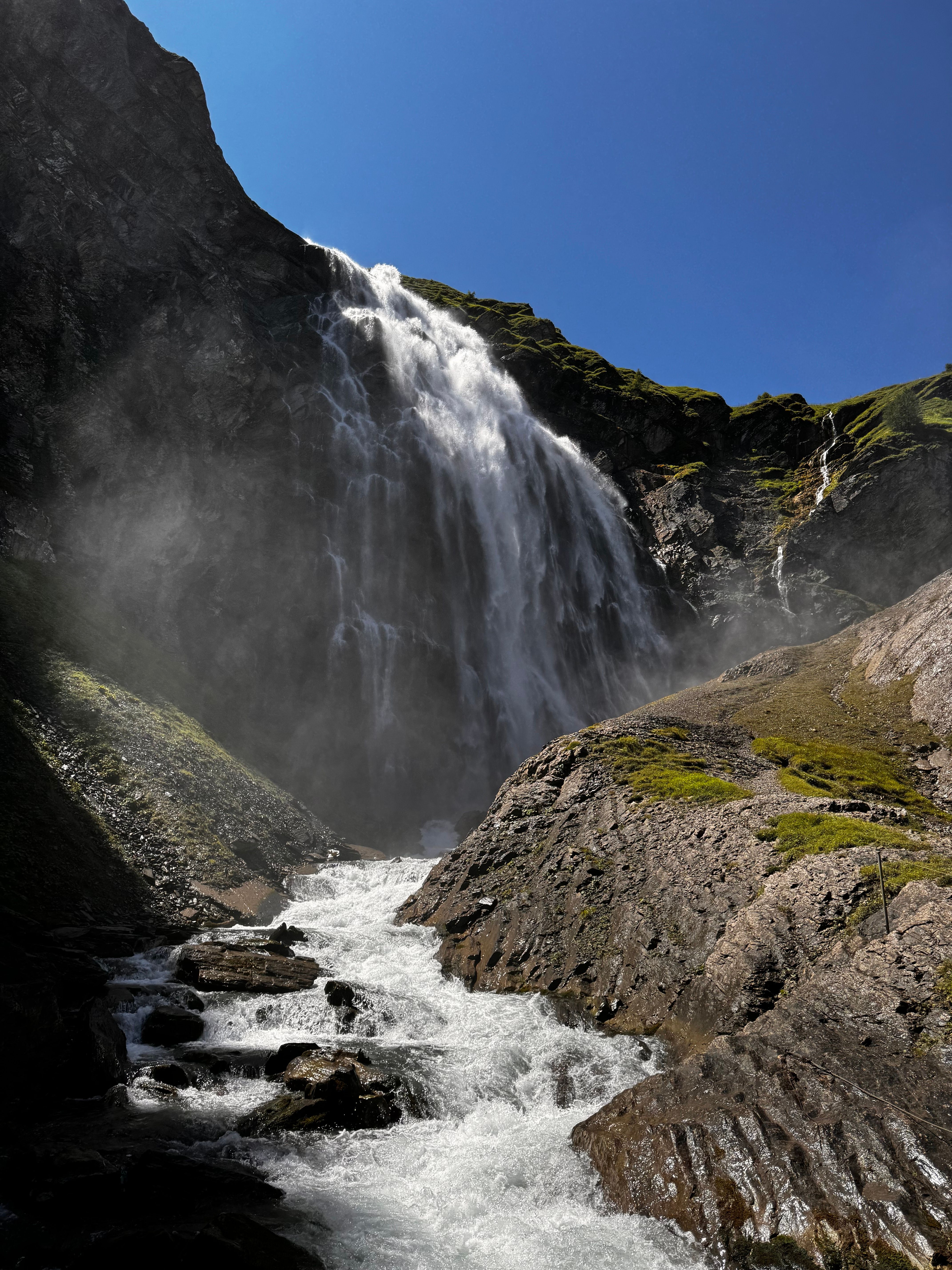 A waterfall is flowing down a mountain · Free Stock Photo