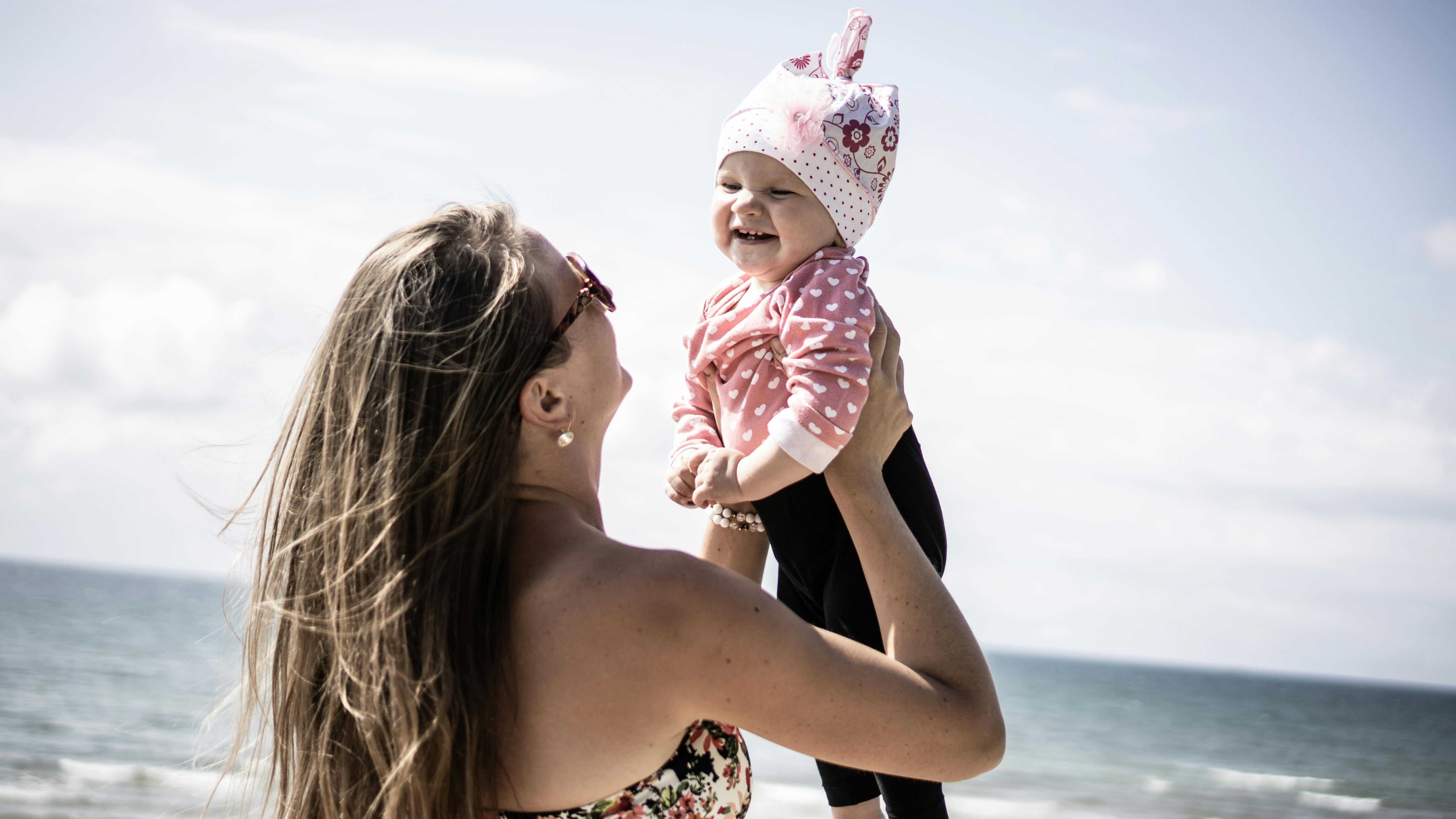 Photo of Woman Carrying A Baby · Free Stock Photo