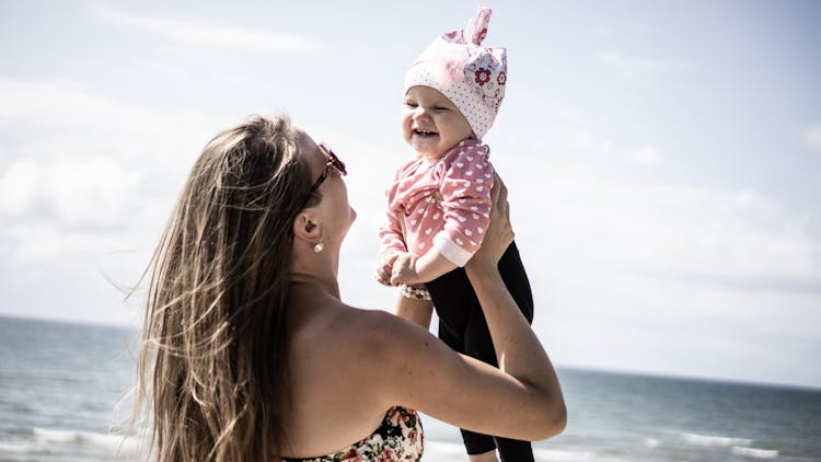 Photo Of Woman Carrying A Baby