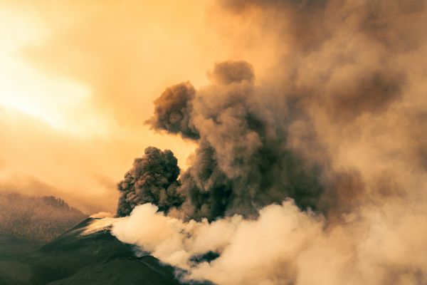 Volcanic eruption billowing smoke at sunrise — photo by christian buehner on Pexels