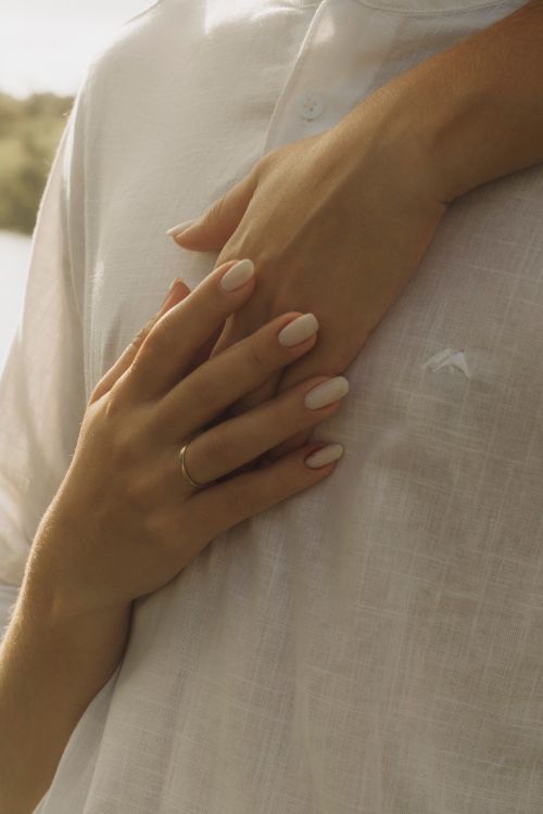 Free Close-up of hands showing affection on a person's chest conveying warmth and intimacy. Stock Photo