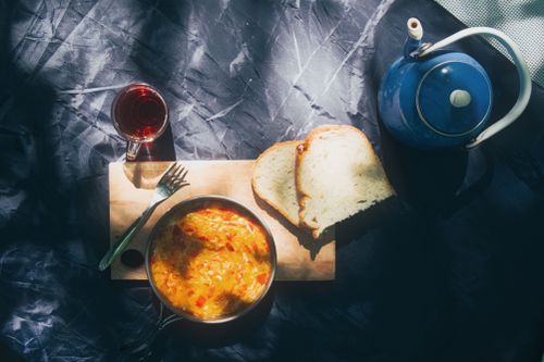 Free Sunny outdoor breakfast with omelette, bread, and tea setting. Stock Photo