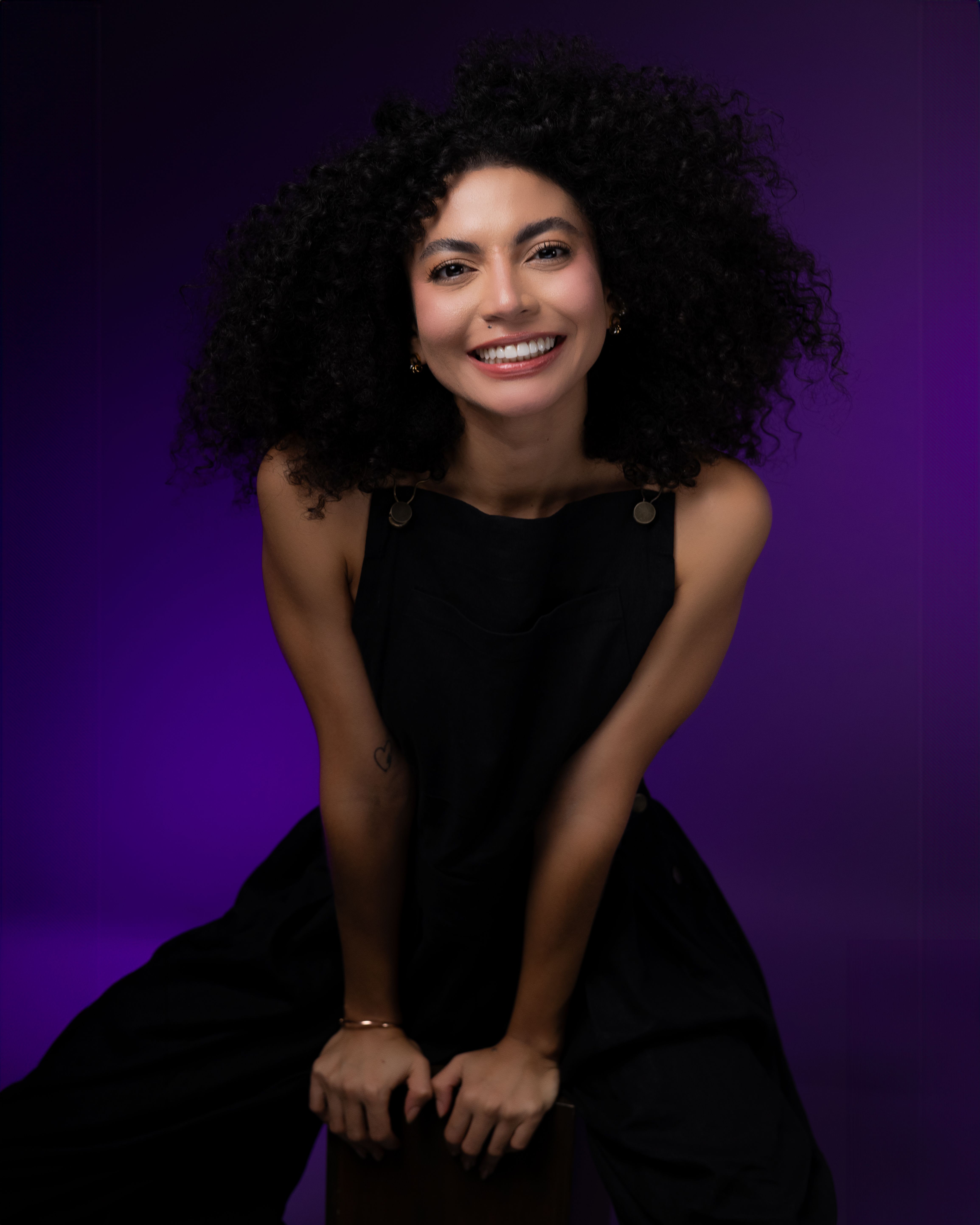 A woman with curly hair posing for a portrait · Free Stock Photo