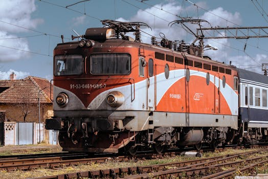 Close-up of a vintage freight train engine at an outdoor rural railway station.