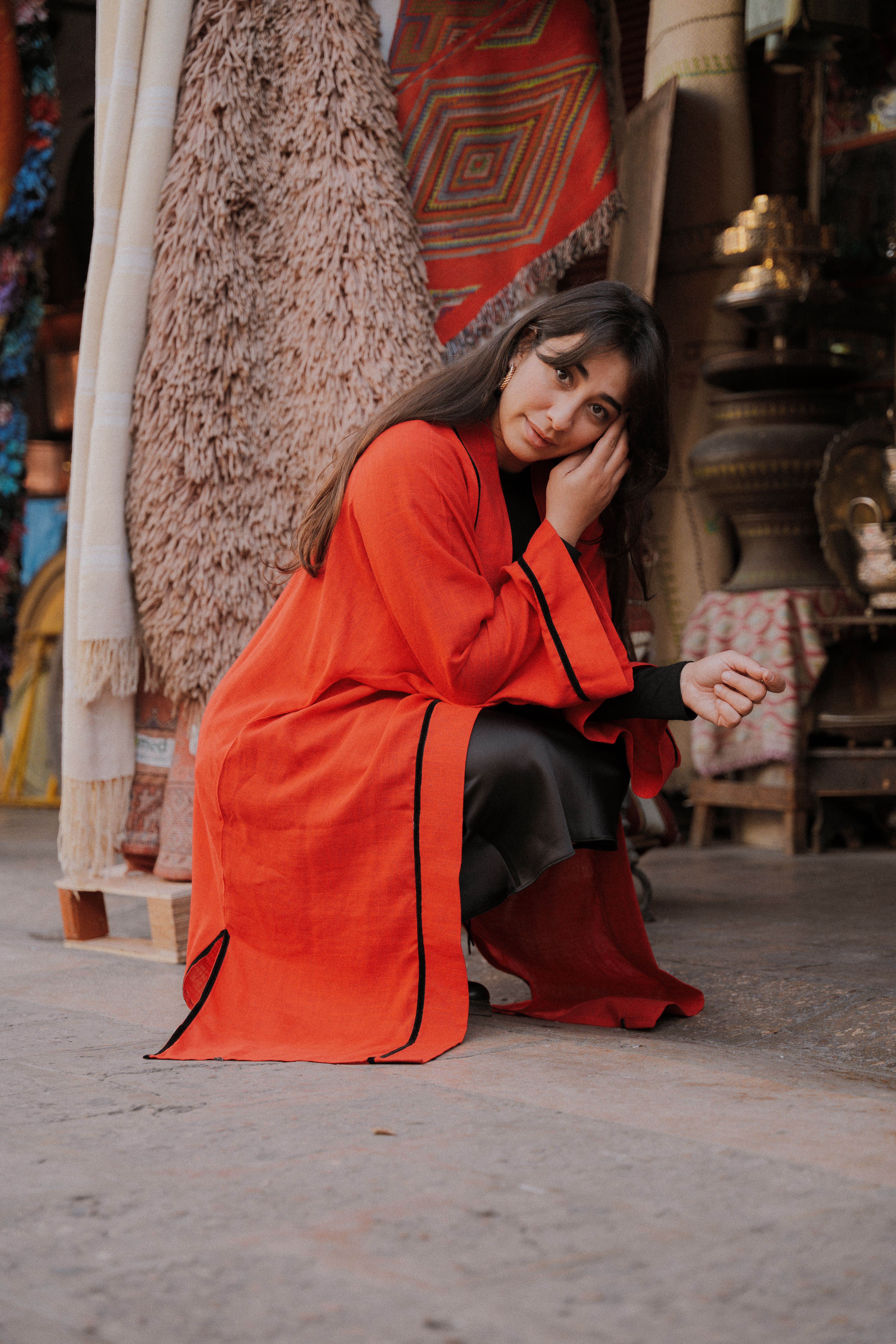 A woman in a red coat sitting on a bench · Free Stock Photo