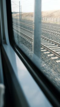 Dynamic image capturing railway tracks from a moving train perspective, symbolizing urban travel.