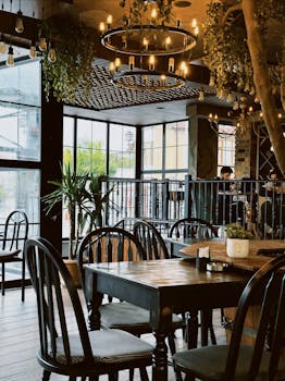 Warm rustic restaurant interior featuring wooden tables, chairs, and ambient lighting.