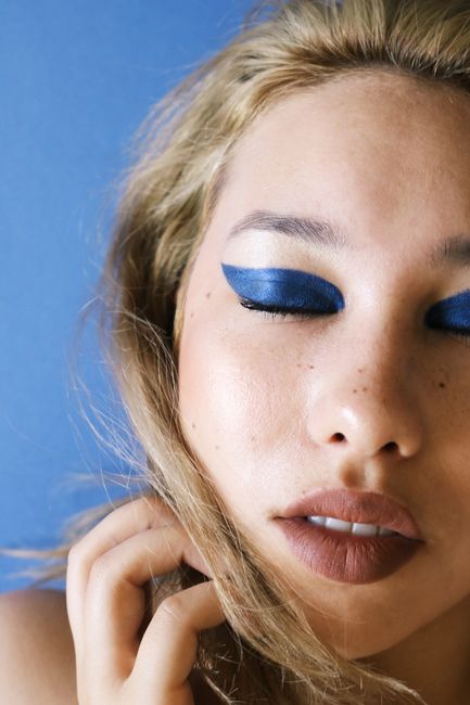 Intense beauty look featuring dramatic blue eyeshadow on a serene female portrait.
