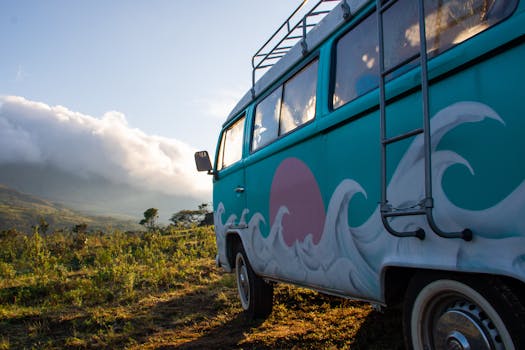 Colorful vintage camper van in a scenic outdoor landscape at sunrise.