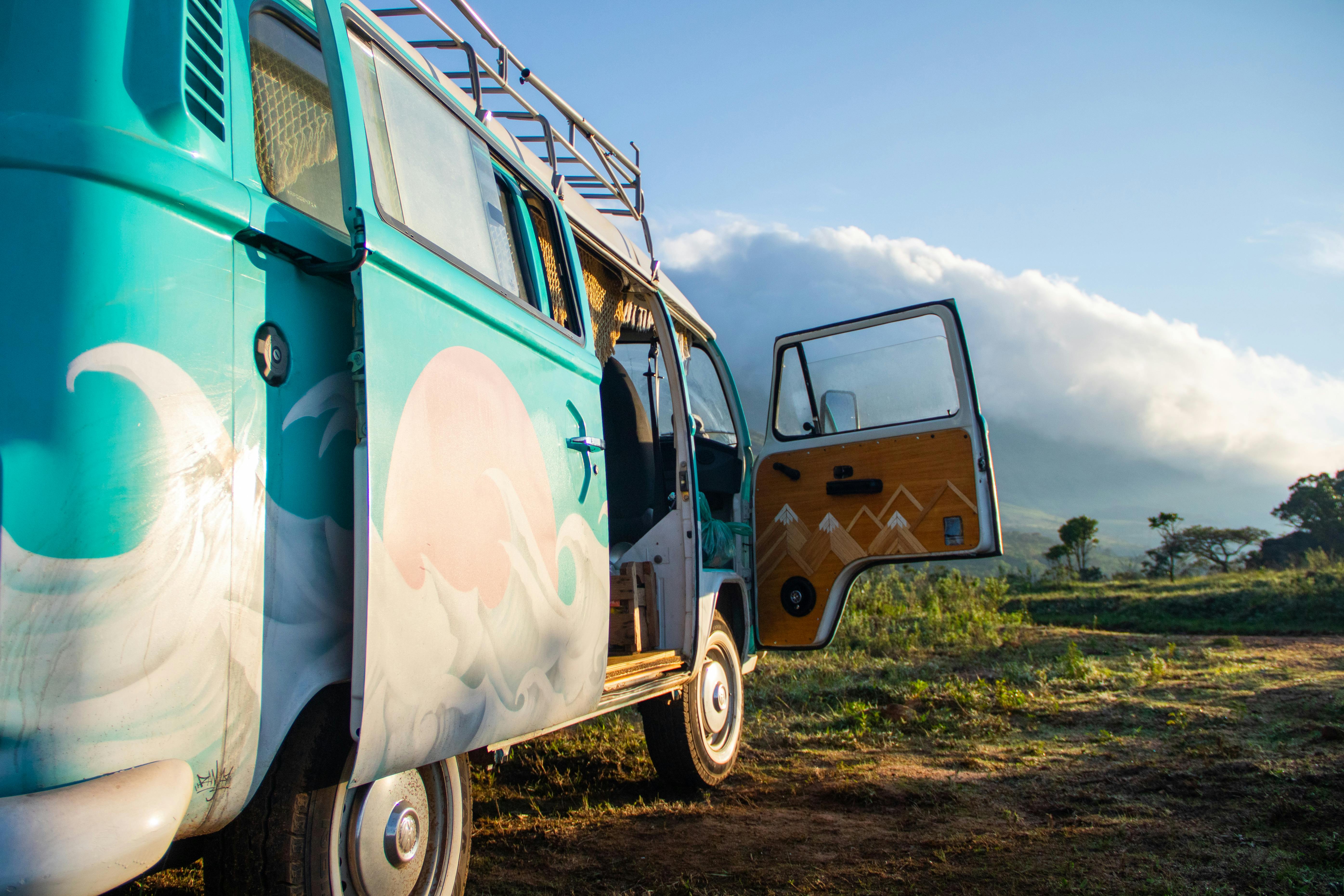 Colorful vintage van parked outdoors with open door, ready for adventure.