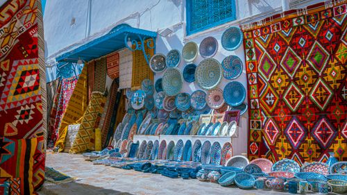 Free Vibrant display of traditional pottery and carpets in Carthage, Tunis. Stock Photo
