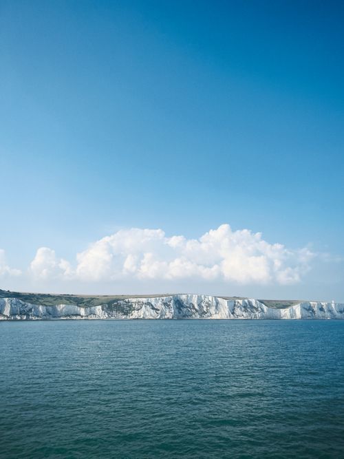 Free Iconic White Cliffs of Dover along the English coast under clear blue skies. Stock Photo